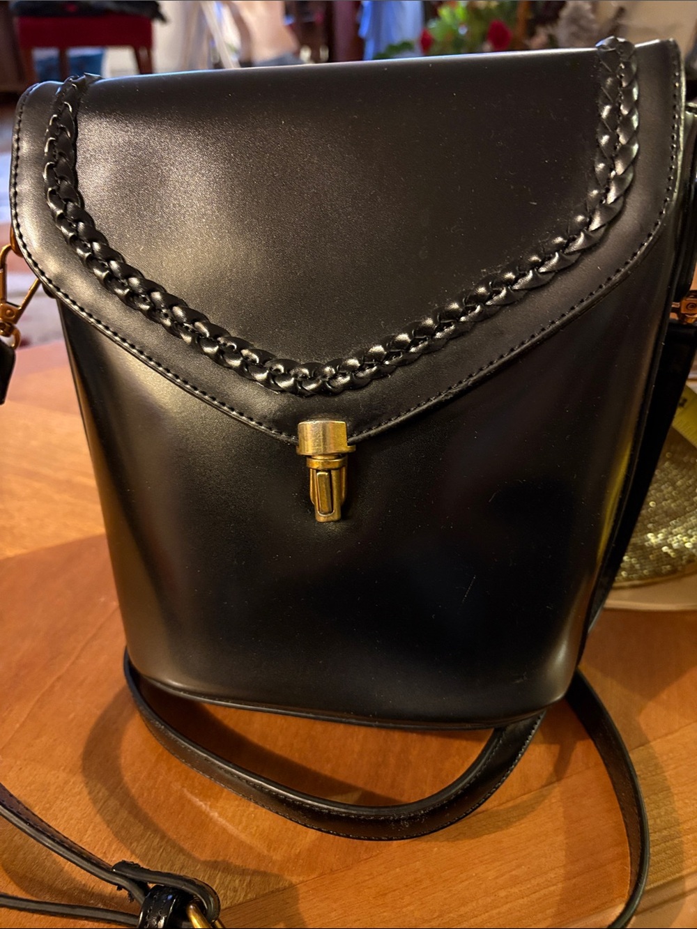 Sleek Black Crossbody Bag with Braided Trim and Gold Push-Lock